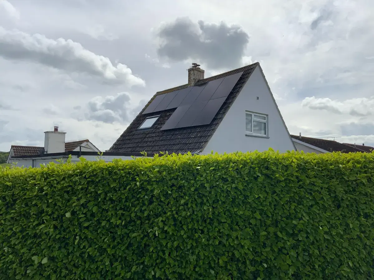 Completed solar installation on residential roof viewed from street