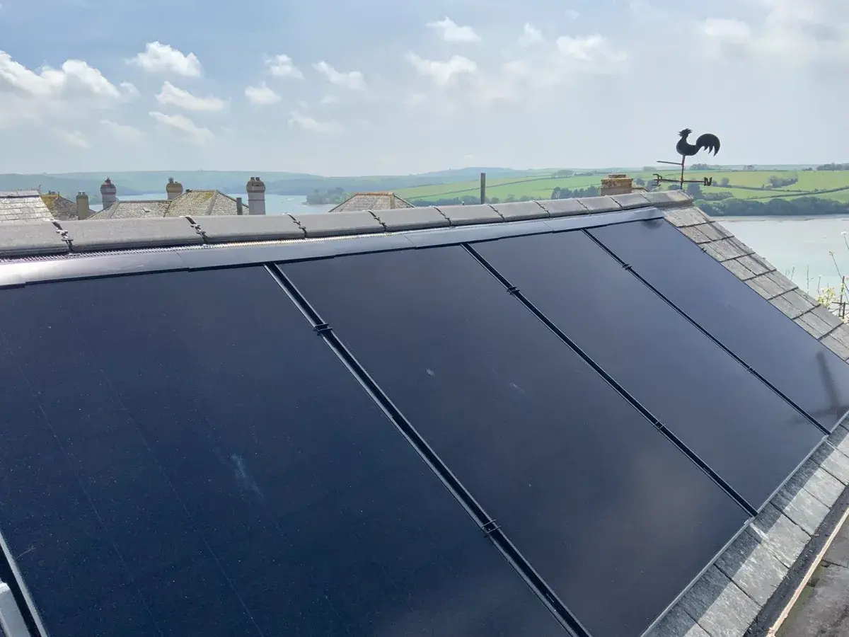 In-roof panels on slate roof with river estuary and Devon countryside