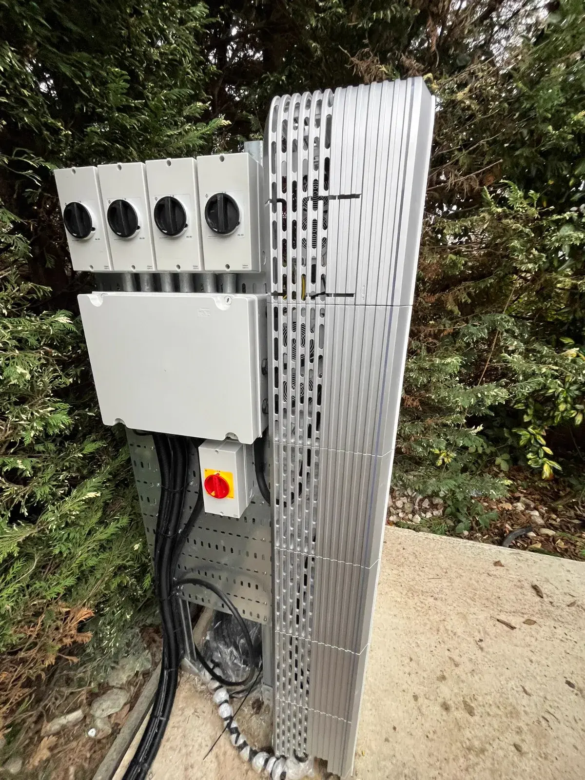Battery and inverter system on exterior garden wall