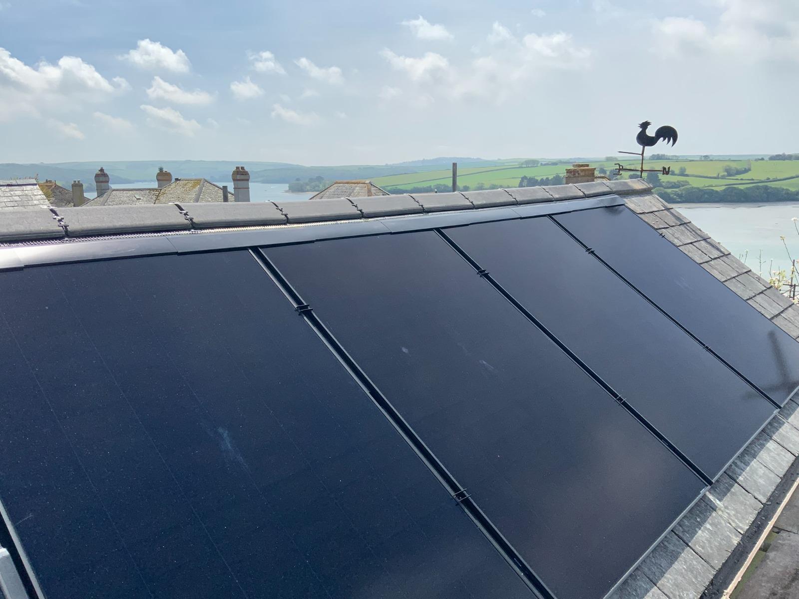 In-roof solar panels flush with slate roof overlooking Devon estuary